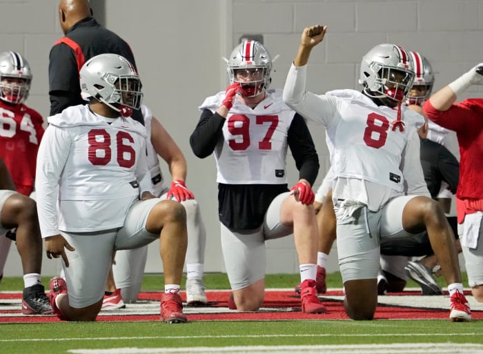 Defensive players Jerron Cage (86), Noah Potter (97) and Javontae Jean-Baptiste (8) stretch during the first practice of spring football for Ohio State University at the Woody Hayes Athletic Center in Columbus on Tuesday, March 8, 2022. Ceb Osufb Spring 0308 Bjp 14